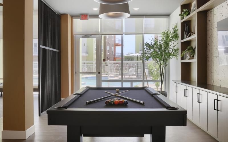 a clubroom with a tv and a pool table