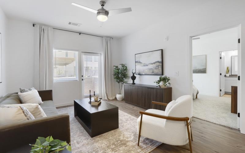 a living room with a couch, chair and tables