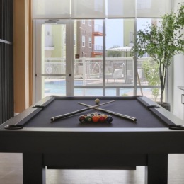 a clubroom with a tv and a pool table