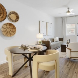 a living room with a couch, tables and chairs