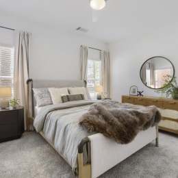 a bedroom with a bed and dressers