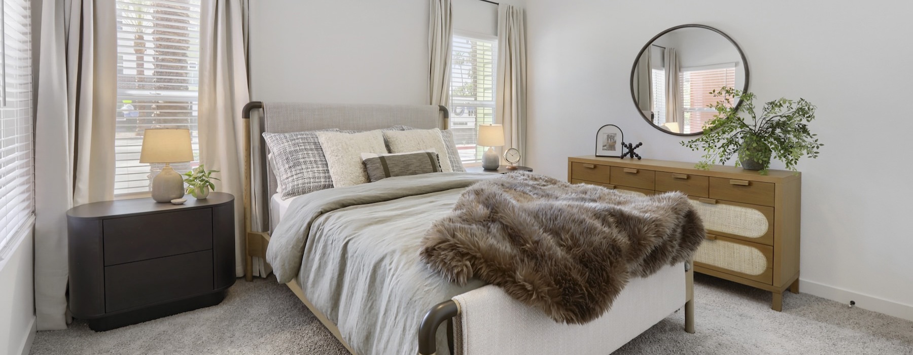 a bedroom with a bed and dressers